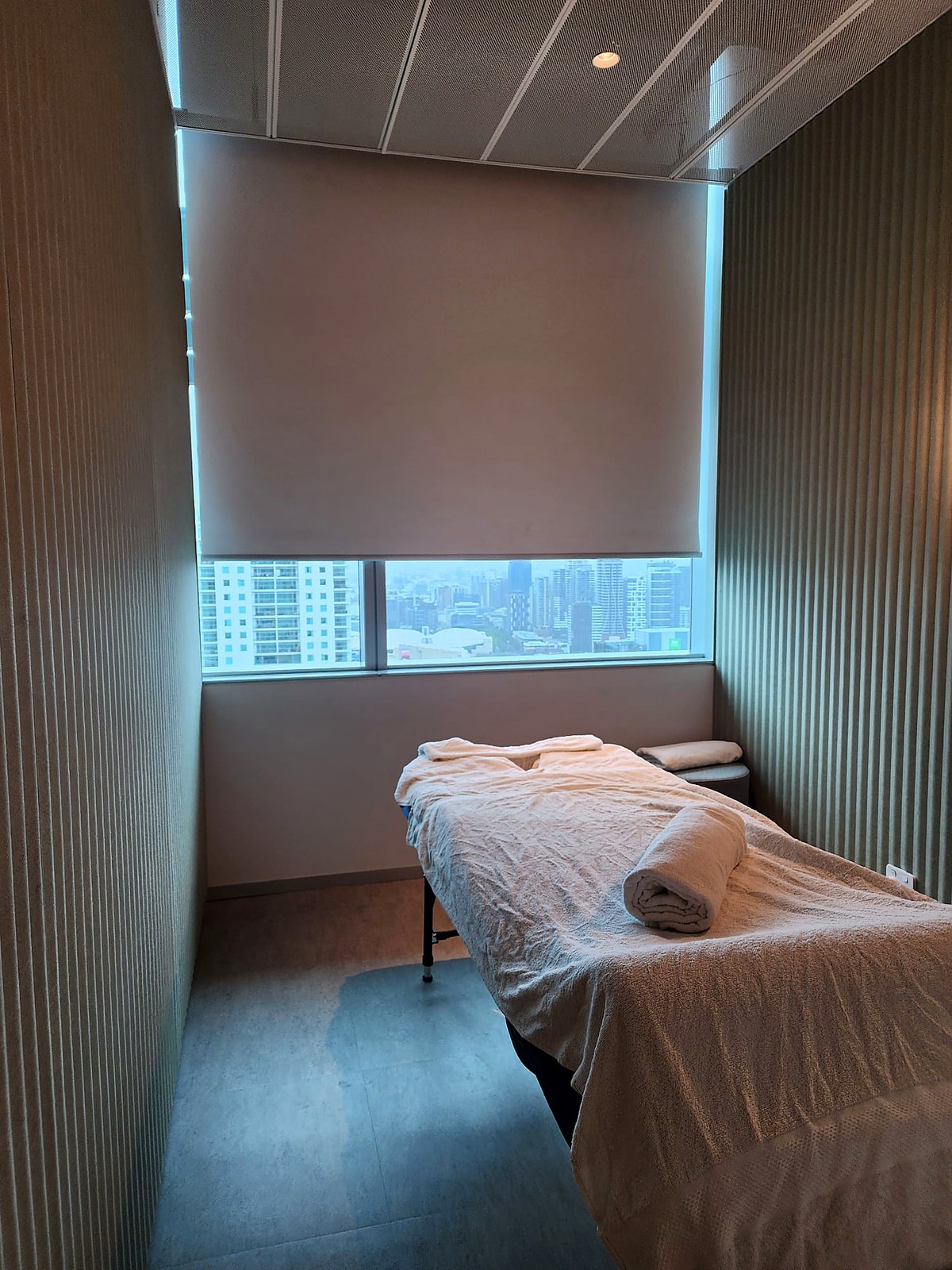 On-site corporate massage setup with towels and Brisbane city view
