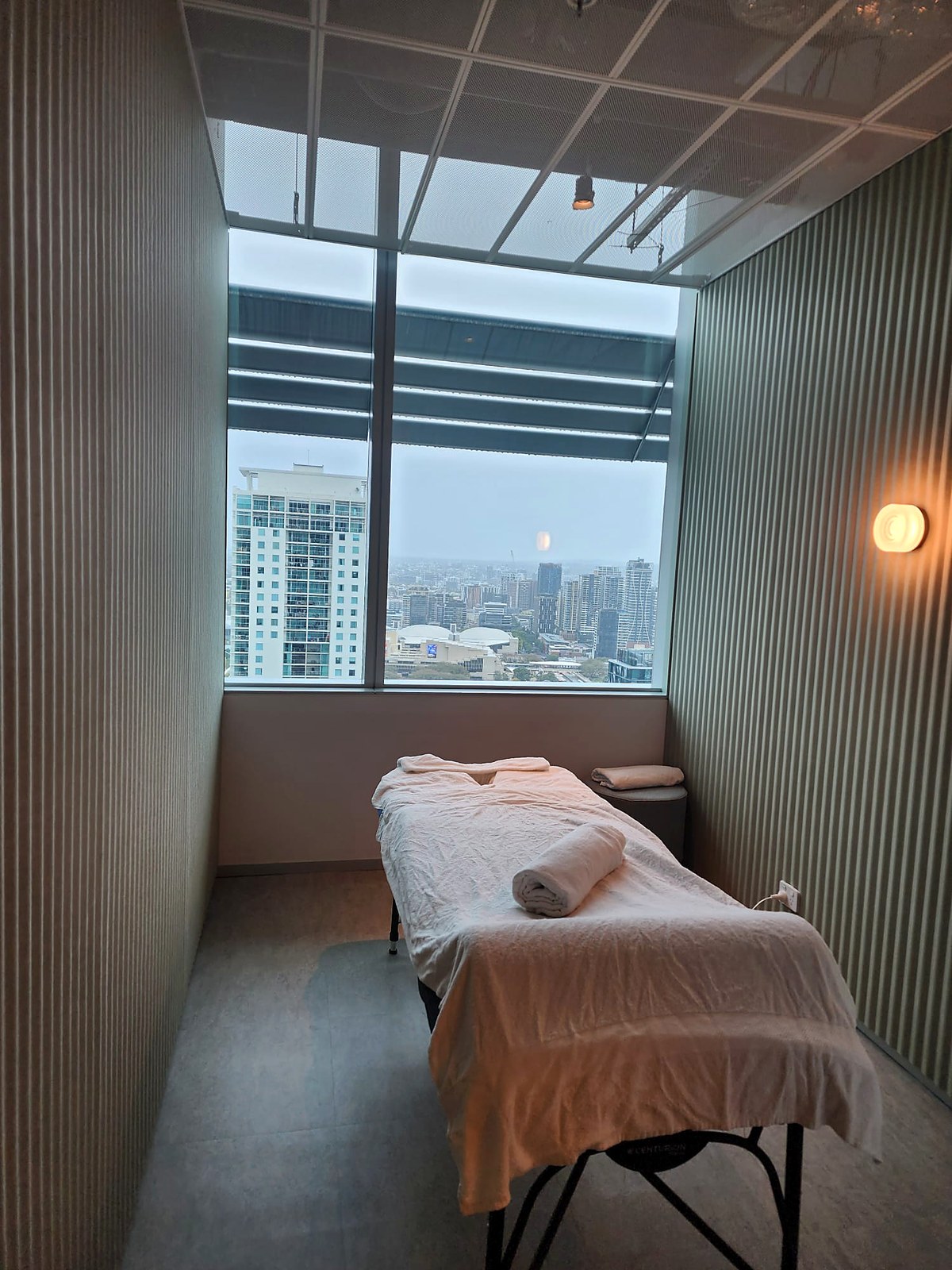 On-site corporate massage table with rolled towels and skyline
